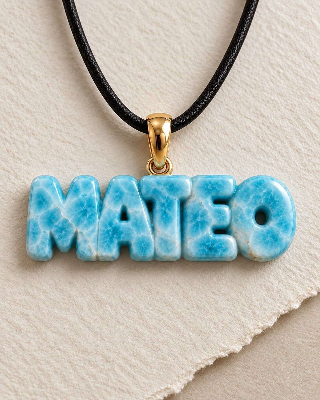 Pendant with the name “MATEO” carved in larimar