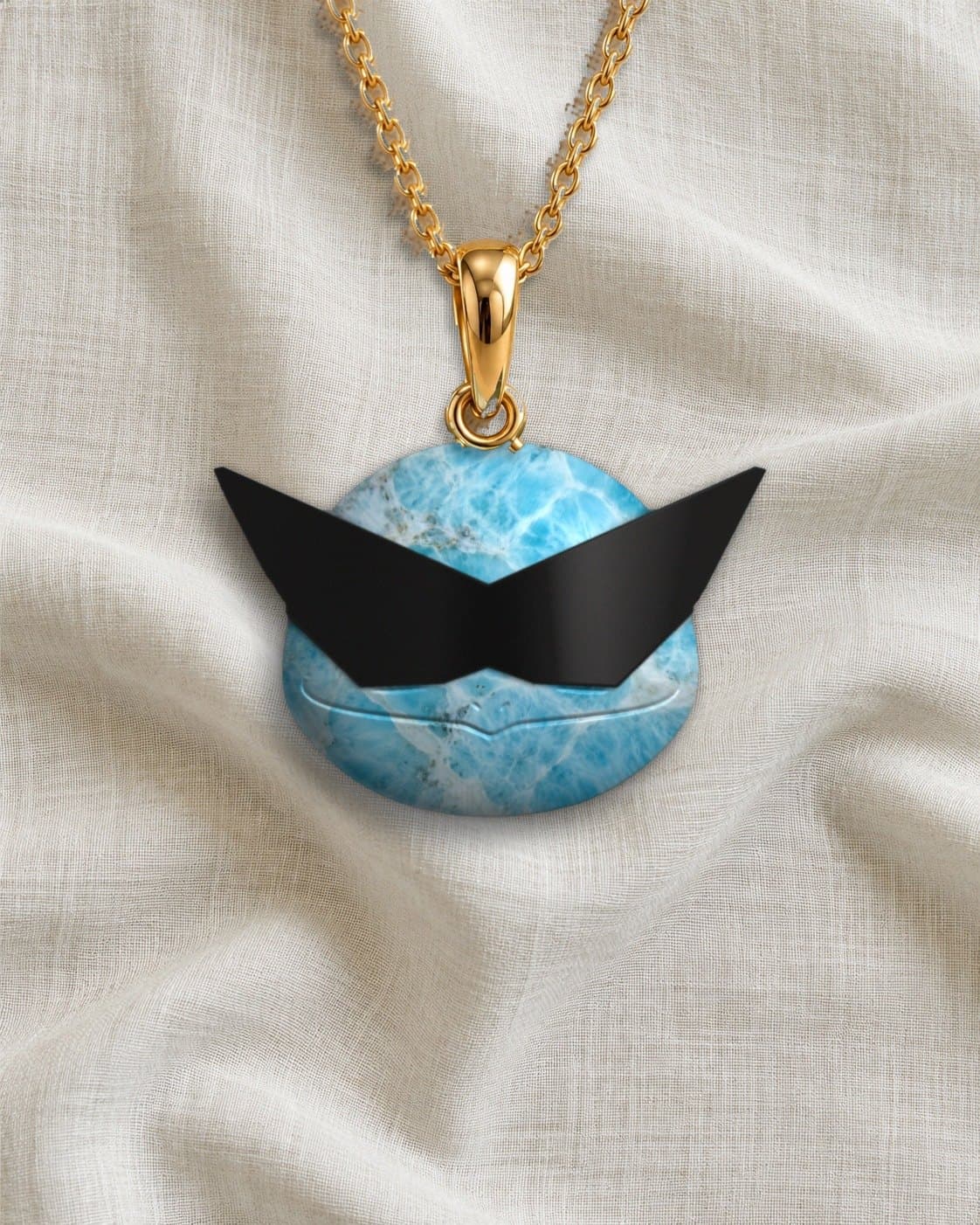 Larimar pendant carved as a character’s head, with black onyx sunglasses